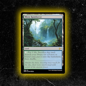 May include: A Magic: The Gathering card titled "Misty Rainforest." The card features a lush rainforest scene with a waterfall and towering trees. The card text describes the land's abilities and flavor text.