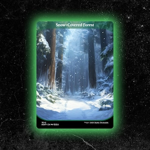 May include: A card featuring a snow-covered forest scene. Tall trees line a path blanketed in snow, with falling snowflakes. The card has a green border and the text "Snow-Covered Forest" at the top. The bottom has text including "10-L" and "MDP ENG.KA".