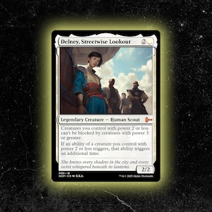May include: A Magic: The Gathering card featuring "Delney, Streetwise Lookout." The card depicts a young person in blue and red clothing, standing in front of a wooden structure. The card text describes the creature's abilities and stats.