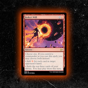 May include: A red and black Magic: The Gathering card titled "Jeska's Will." The card features a sorcery spell with a fiery portal and a silhouetted figure. The text describes the spell's effects, including adding mana and exiling cards.
