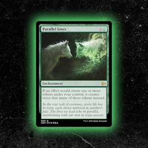 May include: A green Magic: The Gathering card titled "Parallel Lives." The card features two white wolves, one solid and one spectral, facing each other. The card text describes an enchantment that doubles token creation.