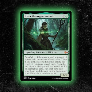 May include: A green Magic: The Gathering card featuring "Nissa, Resurgent Animist." The card depicts an elf scout in a forest setting, with text describing its abilities. The card has a green border and a 3/3 power/toughness.