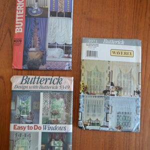 May include: Three Butterick sewing pattern envelopes for window treatments. The top left envelope is number 4370, the bottom left is 5349 titled Easy to Do Windows, and the right envelope is 3971 featuring Waverly designs. Each shows various curtain styles.