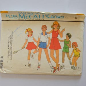 May include: Vintage McCall's 6082 sewing pattern for children's tops, shorts, skirt, and culottes. The pattern envelope features illustrations of children in tennis outfits, with the price of $1.25.