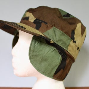 Vintage U.S. ARMY winter hat cap size 7 5/8 woodland camo dated 1989 with ear flaps