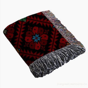 tatreez woven blanket, Palestinian throw blanket, Zahra tatreez blanket, cotton tatreez throw, traditional Palestinian textile, boho woven blanket, fringe cotton throw, cultural couch blanket, Middle Eastern decor, Palestinian heritage gift, bohemian tatreez blanket, tatreez home decor, handmade look blanket, cotton ethnic throw, Arabic design blanket, sofa throw Palestinian, folk art woven blanket, tatreez inspired decor, Palestinian cotton tapestry, artisanal couch throw