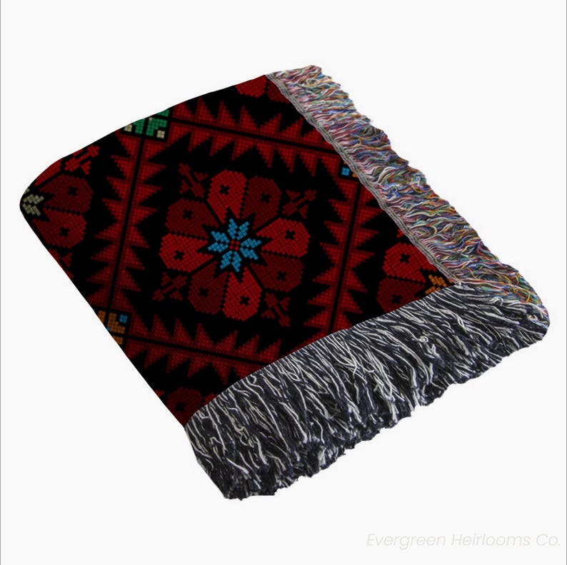tatreez woven blanket, Palestinian throw blanket, Zahra tatreez blanket, cotton tatreez throw, traditional Palestinian textile, boho woven blanket, fringe cotton throw, cultural couch blanket, Middle Eastern decor, Palestinian heritage gift, bohemian tatreez blanket, tatreez home decor, handmade look blanket, cotton ethnic throw, Arabic design blanket, sofa throw Palestinian, folk art woven blanket, tatreez inspired decor, Palestinian cotton tapestry, artisanal couch throw
