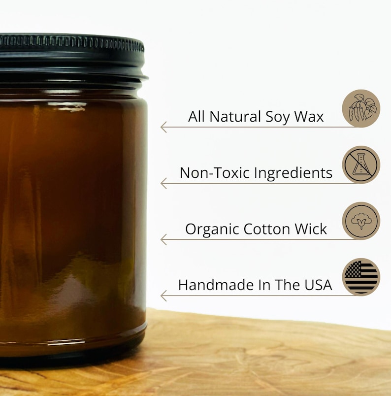 May include: A brown glass candle jar with a black lid. The candle is made with all natural soy wax, non-toxic ingredients, and an organic cotton wick. It is handmade in the USA.