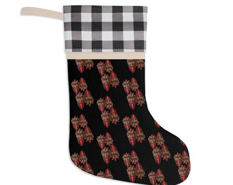 May include: A black Christmas stocking featuring a repeating pattern of a brown and red face design. The top of the stocking has a black and white checkered pattern.