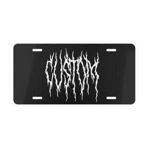 May include: Black metal licence plate with the word "CUSTOM" in a white, jagged font.