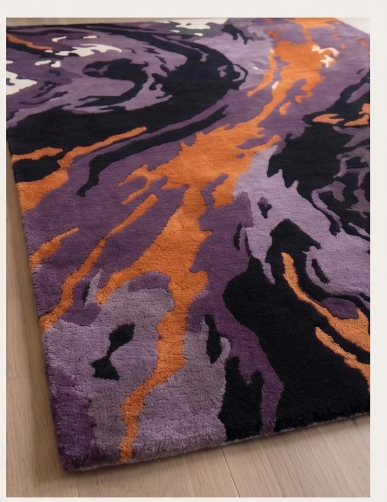 May include: A rectangular area rug featuring an abstract, swirling pattern of deep black, vibrant orange, and multiple shades of purple. The design consists of fluid, organic shapes that flow across the surface, creating a high-contrast visual effect.