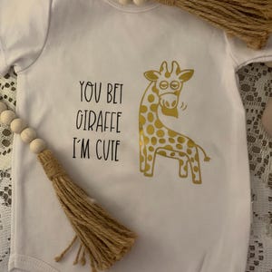 You Bet Giraffe I’m Cute Baby Romper 12-18 months. Includes a free baby gift.