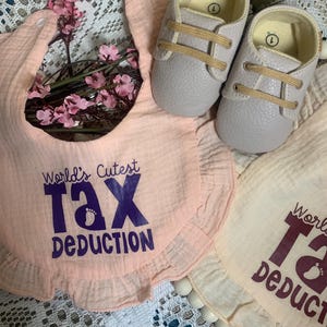 Worlds Cutest Tax Deduction Funny Baby Girl Bib. Includes a free baby gift.