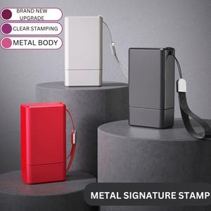 May include: Three metal signature stamps with different coloured bodies: silver, black, and red. Each stamp has a small loop for attaching a lanyard. The stamps are on a grey surface with the text "METAL SIGNATURE STAMP" below them.