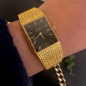 Vintage 1980s Swiss Quartz Yellow Gold Plated Weave Strap Ladies Dress Wristwatch Rectangular Tank Black Dial By Limit International