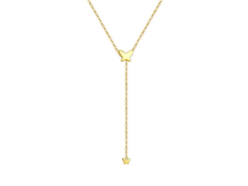 May include: A gold chain necklace with two small butterfly charms. The necklace is a delicate, feminine piece of jewellery.