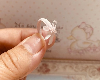 Handmade pink leather wrist headband with a silk bow in the same tone and a tiny flower on the bow.