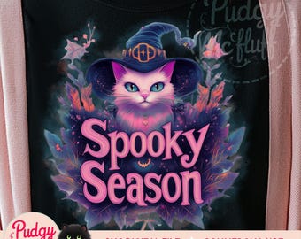 May include: A pink and purple cat wearing a witch hat with the text "Spooky Season" in pink letters on a black background.