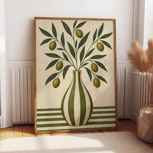 May include: A framed wall art print featuring a vertical striped vase in dark green and cream. The vase holds a branch with dark green leaves and six green olives. The background is a cream colour with horizontal dark green stripes at the base.