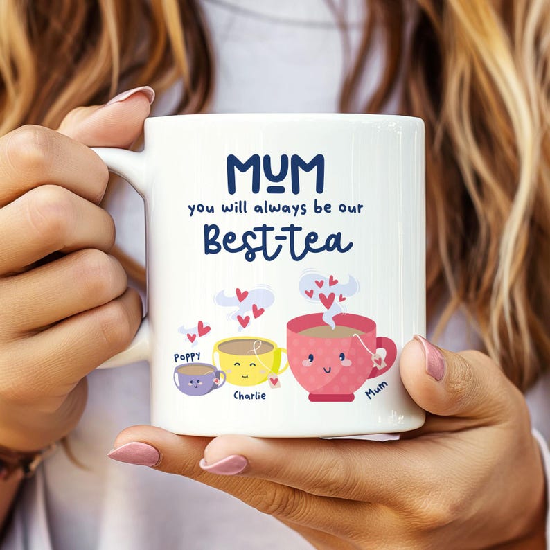 May include: White ceramic mug with the text "MUM you will always be our Best-tea" and three cartoon teacups with the names "Poppy", "Charlie", and "Mum" underneath.