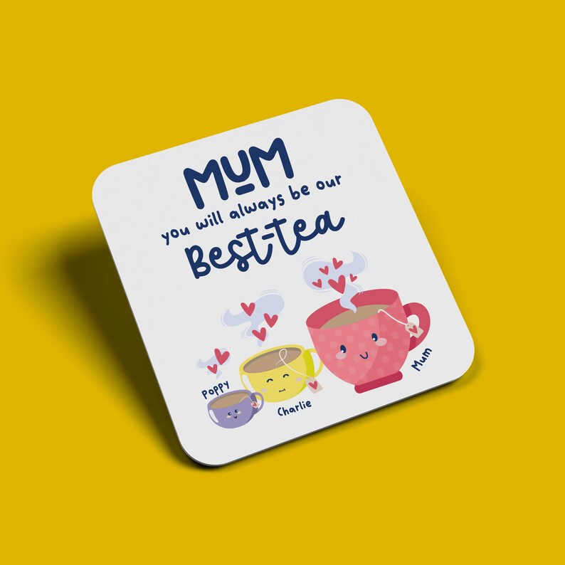May include: White coaster with the text "MUM you will always be our best-tea" in blue. Three cartoon teacups with faces and names "Poppy", "Charlie", and "Mum" are below the text.