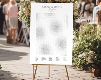 May include: A white wedding word search puzzle on an easel with the words "Sarah & Justin" at the top. The puzzle includes words related to weddings, such as "love", "wedding", "rings", and "bride".