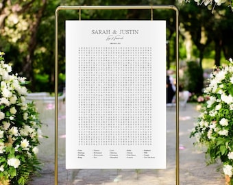 Puede incluir: Un cartel de boda blanco con marco dorado. El cartel presenta un crucigrama con los nombres Sarah & Justin y la fecha 17 de julio de 2021. El crucigrama incluye palabras relacionadas con las bodas, como "amor", "boda", "ceremonia", "recepción", "para siempre" y "sí, quiero".