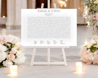 May include: A white sign with a black word search puzzle for a wedding. The sign says "Sarah & Justin" at the top and has a list of wedding-related words to find in the puzzle. The sign is on a white easel.