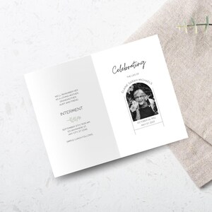 May include: A black and white funeral order of service with a photograph of a woman in an archway frame. The order of service includes the text "Celebrating the life of Elaine Sarah Michaels" and the dates "October 06, 1932 - May 07, 2023".
