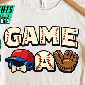 May include: Cream-colored t-shirt with a baseball-themed graphic. The design features the words "GAME DAY" in a baseball stitch font, along with a baseball cap, baseball, and glove. The shirt also has the text "ARTCUTS DIGITALS & PRINTS", "PNG", and "JPG".
