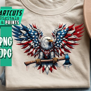 May include: A beige t-shirt featuring a patriotic design of an eagle with wings in the style of the American flag, holding an axe. The shirt is folded on top of a pair of blue jeans. The text "ARTCUTS DIGITALS & PRINTS", "PNG", and "JPG" is visible.