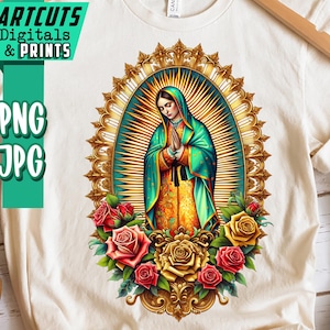 May include: Cream-colored t-shirt featuring a religious illustration of a woman in a green and gold robe, surrounded by a gold halo and roses. The shirt also has the text "ARTCUTS DIGITALS & PRINTS" and "PNG JPG" in a green box.