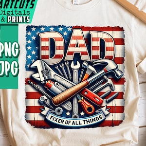 May include: Off-white t-shirt with a graphic design. The design features the word "DAD" in red and white stripes, set against a blue and red American flag background. The design includes tools and the text "FIXER OF ALL THINGS".