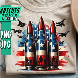 May include: A beige t-shirt featuring a patriotic design with three bullet-shaped objects in red, white, and blue, resembling the American flag. The shirt also has silhouettes of soldiers and fighter jets. The text "ARTCUTS DIGITALS & PRINTS" and "PNG JPG" is visible.