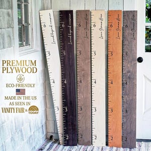 May include: A set of three ceramic vases in varying heights. The vases have a matte finish in shades of cream, beige, and brown. The tallest vase is approximately 10 inches tall.