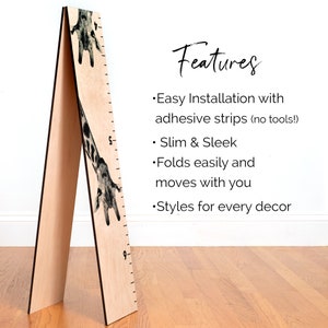 May include: A wooden height chart with a giraffe design. The chart features a ruler with markings and numbers, and the text "Features" and bullet points describing the product.