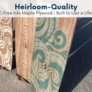 May include: Wooden growth charts with decorative wave patterns in shades of brown and teal. Each chart has a ruler with the number 3 marked. The text "Heirloom-Quality" and "VOC-Free Inks Maple Plywood | Built to Last a Lifetime" is visible.