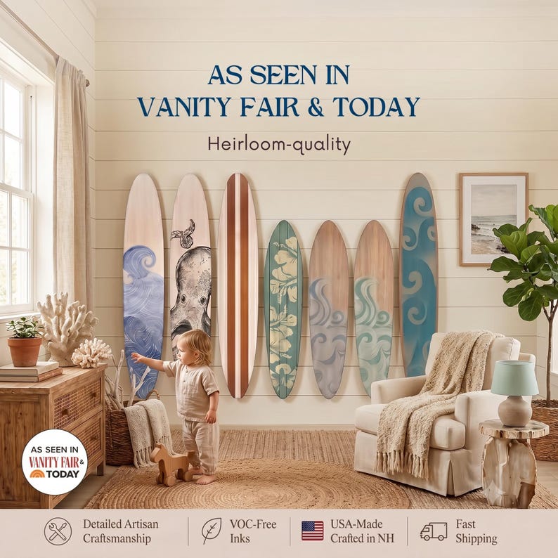May include: Seven decorative wooden surfboards mounted on a wall, featuring various designs including blue waves, an octopus illustration, and floral patterns. The text reads AS SEEN IN VANITY FAIR & TODAY and Heirloom-quality.
