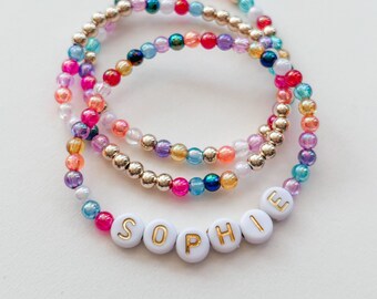 personalized bracelet set, luxe gold layering bracelets gift for her, colorful iridescent name bead bracelets, stretchy friendship bracelets