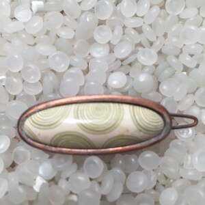 vintage hair barrette , copper tone Barrette ivory with soft green rings , aged patina