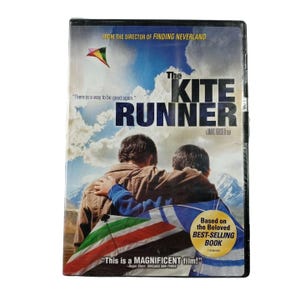 May include: A DVD case for the film The Kite Runner, featuring two individuals seen from behind against a mountain landscape. A colorful kite is visible in the sky. Text includes: From the director of Finding Neverland, There is a way to be good again, and Based on the Beloved BEST-SELLING BOOK.