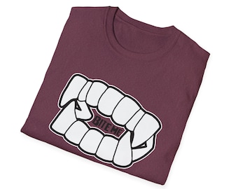 May include: A maroon t-shirt with a white graphic of a set of vampire fangs with the text "BITE ME" printed in black.