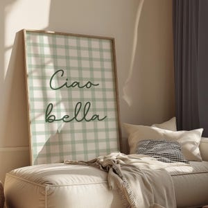 May include: A framed green and white gingham print with the text "Ciao bella" in dark green cursive lettering.