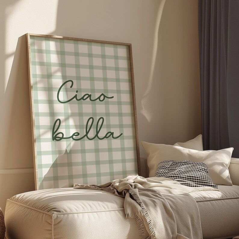 May include: A framed green and white gingham print with the text "Ciao bella" in dark green cursive lettering.