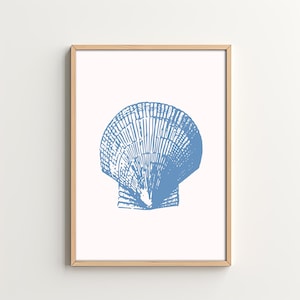 May include: A blue and white illustration of a seashell in a light wood frame. The seashell is a scallop with a detailed design.