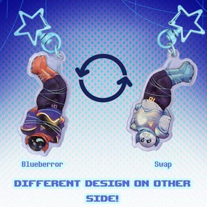 May include: Two acrylic keychains with cartoon characters, one in orange and black, the other in blue and white. Each keychain has a star-shaped clasp. Text reads "Blueberror Keychains" and "Different design on other side!"