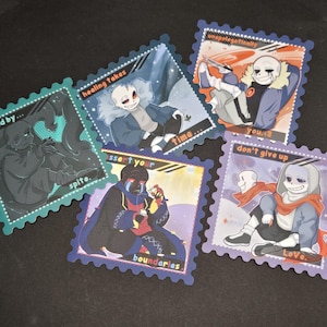 May include: Five square stickers with cartoon character illustrations in a stamp design. Each sticker features a different character with text such as "fueled by...spite" and "don't give up Love.". The stickers have a scalloped edge.