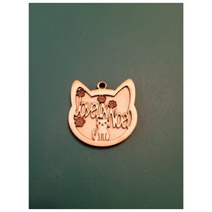 Fichier à télécharger, Ornement tête de chat avec des empreintes et un chat, inscrit joyeux noël et le fond.