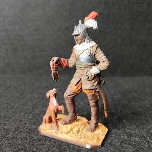 Tin figurine of a 17th century German cavalryman with a dog.