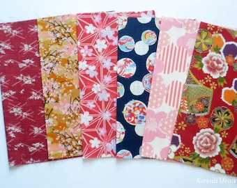 May include: Six fabric swatches with different Japanese-inspired patterns. The swatches are red, pink, blue, and gold with floral and geometric designs.